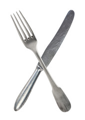 Crossed vintage crossed fork and knife isolated on bell background. Rustic style.