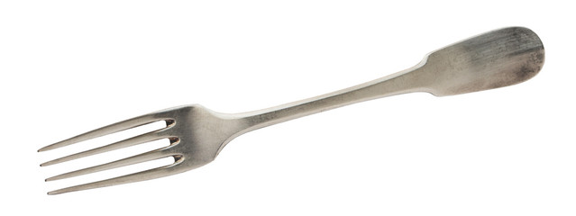 Beautiful old vintage fork isolated on white background. Top view. Retro silverware