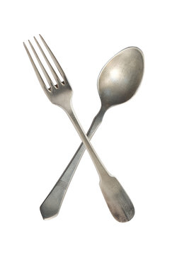 Crossed Vintage Spoon And Fork Isolated On Bell Background. Rustic Style.