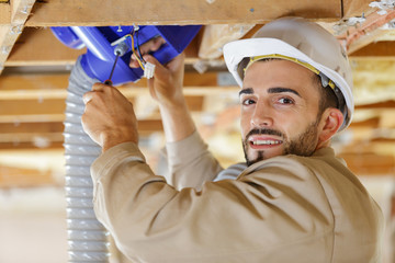 builder repairing the ventilation grates