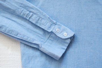 Sleeve of blue shirt. Clothes concept. Details of clothes