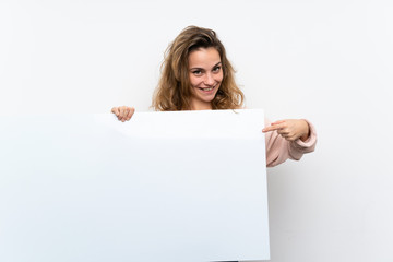 Young blonde woman holding an empty white placard for insert a concept