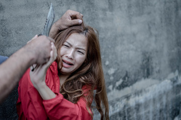 Fototapeta premium A knife in the hands of a cruel man, Criminals using violence to intimidate women, intimidating and imprisoning a woman, Stopping violence women concept.