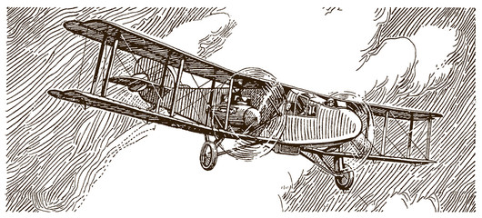 Historical commercial aviation biplane flying in front of a dark cloudy sky © M