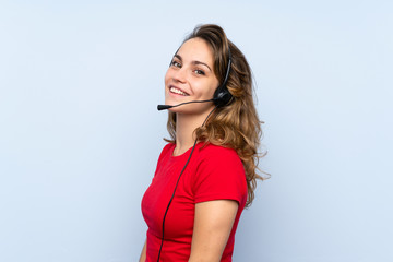 Young blonde woman working with headset