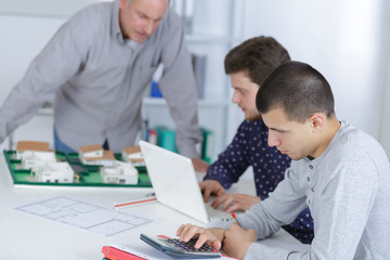 persistent architect students working on a draft