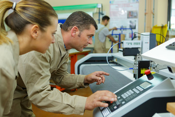 man and woman operating with a machine