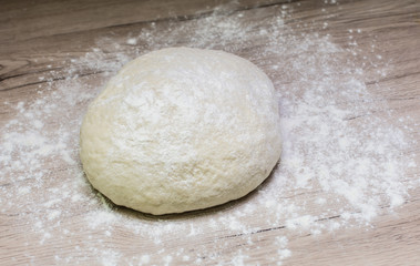 Fototapeta na wymiar Dough with flour on board