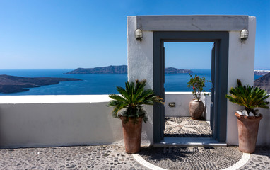 Typical design decoration door of Santorini Greece with way into the sea with copy space 