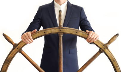 Businessman holding ship rudder.