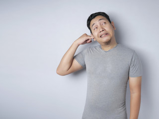 Asian Man Picking Ear with Finger