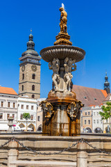 Main square with Samson fighting the lion fountain sculpture and bell tower in Ceske Budejovice. Czech Republic.