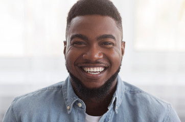 Portrait of black millennial guy with happy smile on face