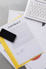 Mobile phone on signed contract. Phone negotiations on contract issue. Business concept.