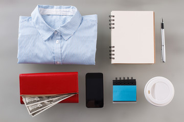 Money in wallet, shirt and stationery. First salary of future successful lady. Career start.