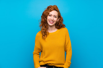 Redhead woman with yellow sweater laughing