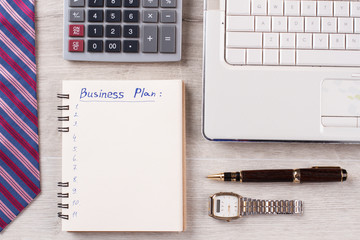 Watch, pen and notebook. Office flatlay on wooden background close up. Office work concept.