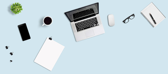 Top view office desk with laptop, smartphone, pen, notebook, paper clip, glasses, flower vase,...