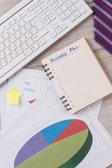 Clerk's tabletop close up. Keyboard and papers. Tie and notepad. Office concept.