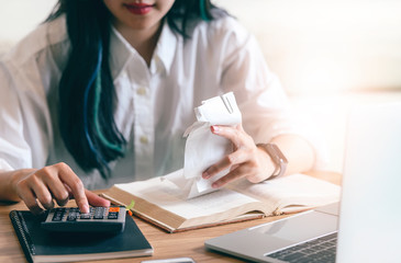 Closeup young woman calculating accounting budget with calculator.