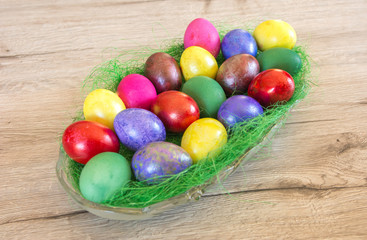 Fototapeta na wymiar Colorful easter eggs in a basket