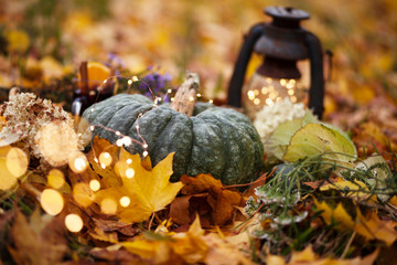 halloween and thanksgiving background with pumpkins,lantern,mulled wine outdoor