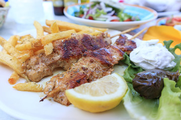 Souvlaki with cheese and fries in Corfu Greece