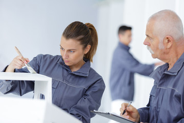 supervisor assessing young woman painting