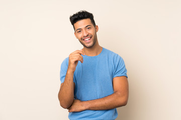 Young handsome man over isolated background smiling a lot