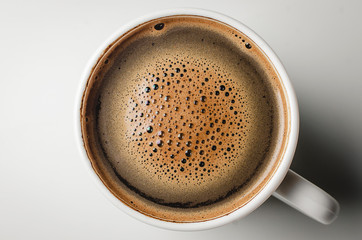 Top view of a cup of coffee. Coffee foam isolated on white background with clipping path.
