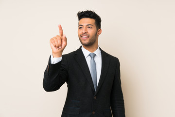 Young handsome businessman man over isolated background touching on transparent screen
