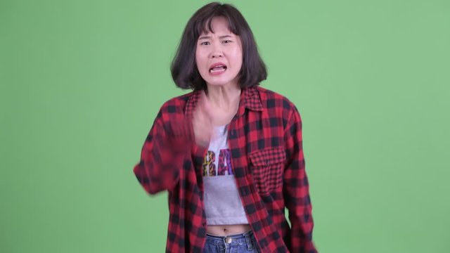 Angry Asian hipster woman talking and complaining