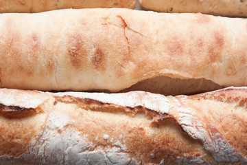 Ffreshly baked long baguettes as food background