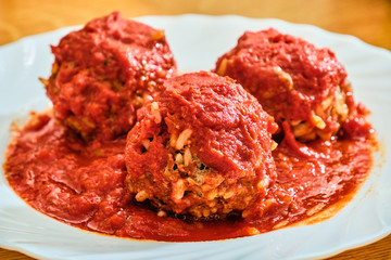 Meat balls with rice with tomato sauce on white plate