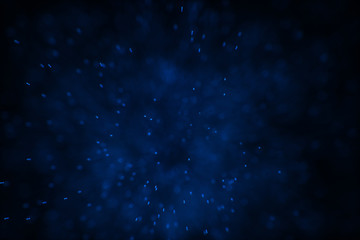 Flowing and glowing particles with dark background, 3d rendering