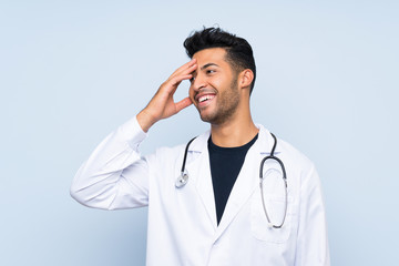 Young doctor man over isolated blue wall has realized something and intending the solution