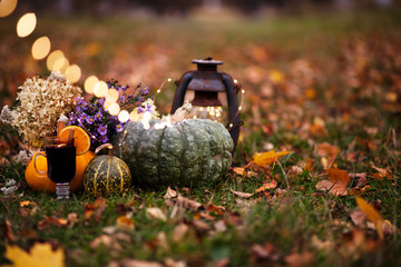 halloween and thanksgiving background with pumpkins,lantern,mulled wine outdoor