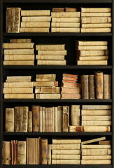 antique books on old wooden shelf.