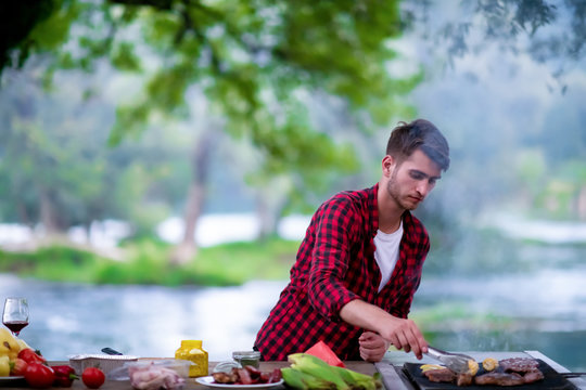 Man cooking tasty food on barbecue grill