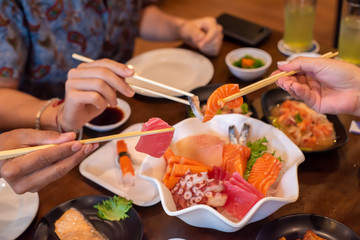 People eating delicious food With salmon and many seafood