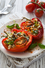 Bell peppers filling with vegetables, bulgur and cheese close up