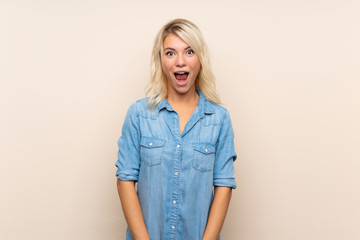 Young blonde woman over isolated background with surprise facial expression