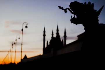 Silhouette of Kul Sharif mosque and dragon at sunset.