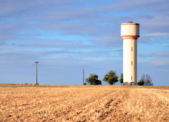 Fototapeta na wymiar Water tower in the fields