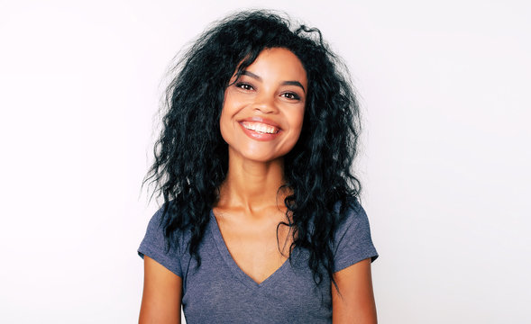 Sheer Beauty. Front Portrait Of Attractive African American Woman With Fuzzy Jet-black Hair And Almond-shaped Eyes, Looking At The Camera And Smiling Broadly.