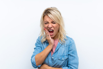 Young blonde woman over isolated white background with toothache