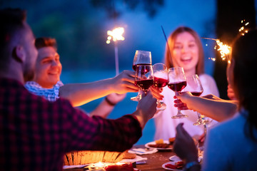 happy friends having french dinner party outdoor