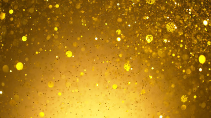 Abstract golden glittering background with blur dots.