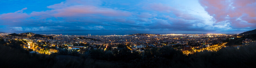 Fototapeta premium Panoramic view of Barcelona from the Tibidabo hillside at dusk after a storm
