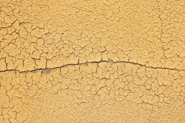 yellow putty is cracking and moving away from the surface, a large crack